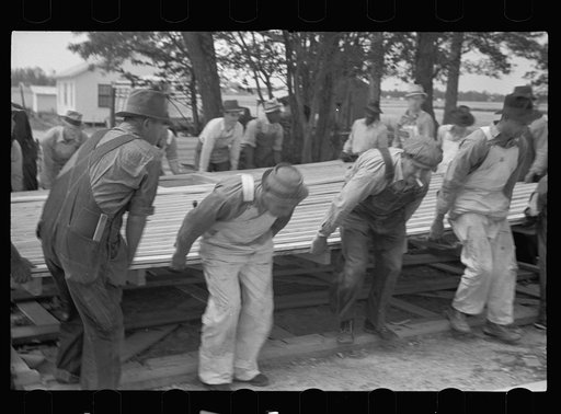Untitled photo, possibly related to: Loading wall of prefabricated house onto truck, Roanoke Farms, North Carolina