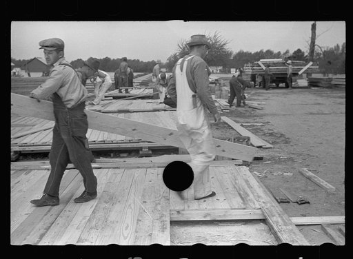 Untitled photo, possibly related to: Loading wall of prefabricated house onto truck, Roanoke Farms, North Carolina