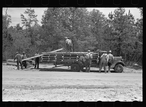 Unloading parts of prefabricated house, preparatory to erecting, Roanoke Farms, North Carolina