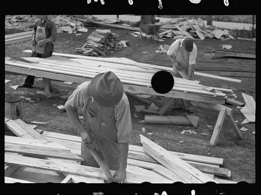 Untitled photo, possibly related to: Carpenter working on gable of prefabricated house, Roanoke Farms, North Carolina