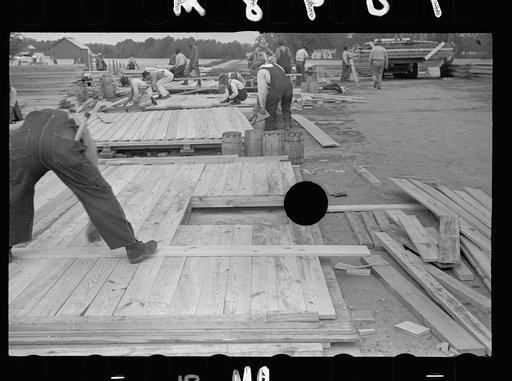 Untitled photo, possibly related to: Carpenter working on gable of prefabricated house, Roanoke Farms, North Carolina