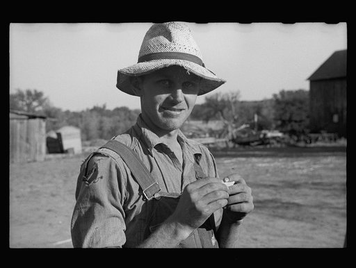 Rehabilitation client rolling a cigarette. Gage County, Nebraska