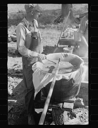 Farmer working at sorghum mill, Lancaster County, Nebraska