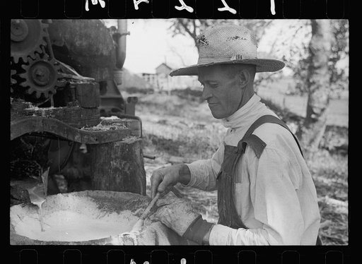 Farmer working at sorghum mill, Lancaster County, Nebraska