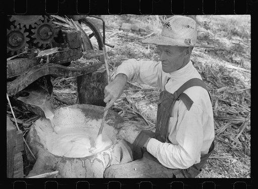 Farmer working at sorghum mill, Lancaster County, Nebraska
