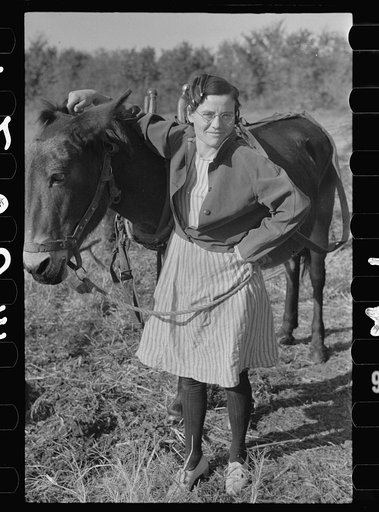 Thirty year-old mule; the girl is twenty-five. Farm in Coffey County, Kansas
