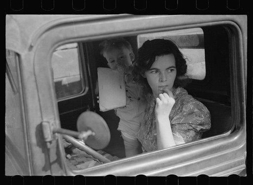 Farm wife waiting in the car while her husband attends the auction. Oskaloosa, Kansas