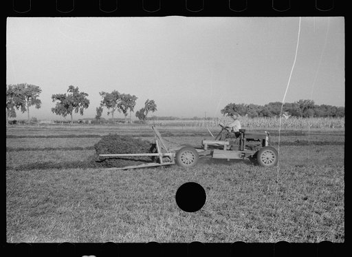 Untitled photo, possibly related to: Using a power rake on the alfalfa fields of Dawson County, Nebraska. Dawson County is the greatest alfalfa producing center in the world