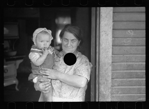 Untitled photo, possibly related to: Wife of coal miner with grandchild. Kempton, West Virginia