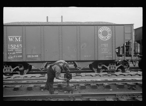 Yardman polishing light on railroad switch. Elkins, West Virginia