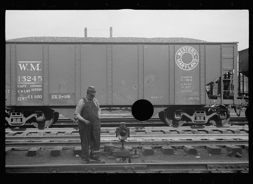 Untitled photo, possibly related to: Yardman polishing light on railroad switch. Elkins, West Virginia