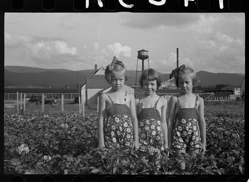 Daughters of a Tygart Valley homesteader. House and factory in backgorund.  West Virginia