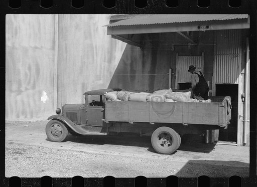Untitled photo, possibly related to: Unloading sacks of wheat at elevator, Minneapolis, Minnesota