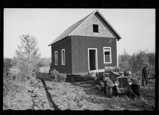 Farmer of cut-over land moving house to new land. The government bought up the land on which he formerly farmed to take it out of farming. Lake of the Woods County, Minnesota