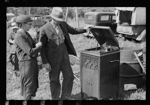 Untitled photo, possibly related to: Farmer and wife examining phonograph at auction near Tenstrike, Minnesota