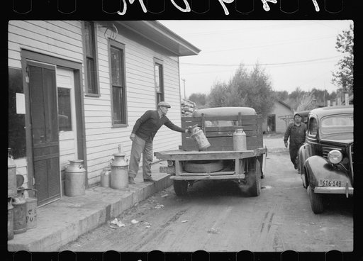 Untitled photo, possibly related to: Unloading milk cans at cooperative creamery which has received a loan from the FSA (Farm Security Administration), Coleraine, Minnesota