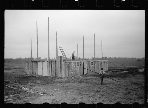 Farmer and son, rehabilitation clients, building barn which FSA (Farm Security Administration) loan enables them to build, Lake of the Woods County, Minnesota