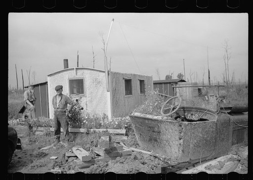 Young farmer of cut-over land in front of his home, Lake of the Woods County, Minnesota