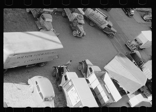 Trucks loading at farm implement warehouse, Minneapolis, Minnesota