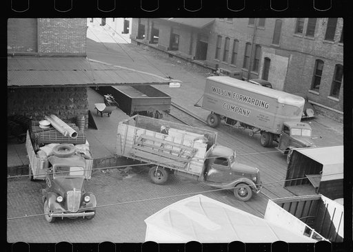 Trucks loading at farm implement warehouse, Minneapolis, Minnesota