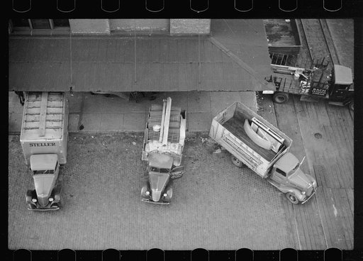 Trucks loading at farm implement warehouse, Minneapolis, Minnesota