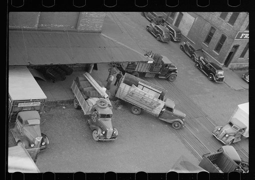 Untitled photo, possibly related to: Trucks loading at farm implement warehouse, Minneapolis, Minnesota