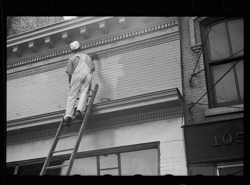 Painting front of building, Minneapolis, Minnesota