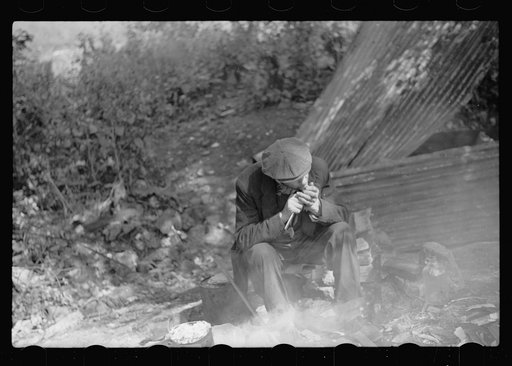 Untitled photo, possibly related to: Man in hobo jungle killing turtle to make soup, Minneapolis, Minnesota