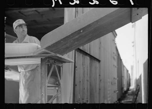 Untitled photo, possibly related to: Loading freight car with sacks of flour, Minneapolis, Minnesota