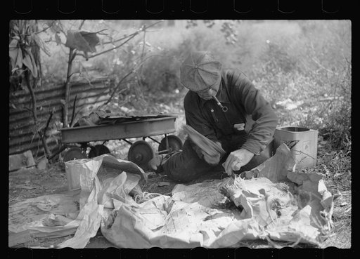 Untitled photo, possibly related to: Man in hobo jungle killing turtle to make soup, Minneapolis, Minnesota