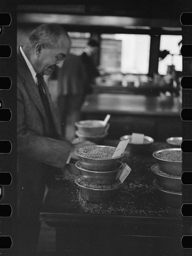 Untitled photo, possibly related to: Buyer examining oat samples at open market, Minneapolis Grain Exchange, Minnesota