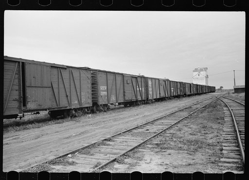 Untitled photo, possibly related to: Grain elevators along railroad tracks, Sisseton, South Dakota