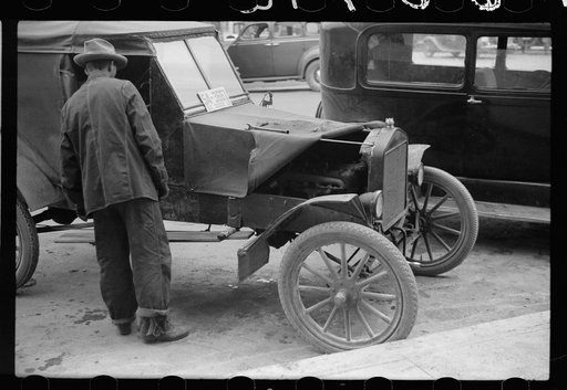 Untitled photo, possibly related to: Farmer with 1913 model Ford on main street of Sisseton, South Dakota