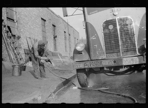 Untitled photo, possibly related to: Washing truck which has returned from trip, Minneapolis to Chicago. Minneapolis, Minnesota