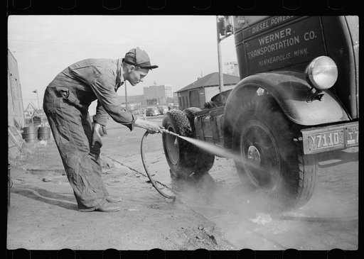 Washing truck which has returned from trip, Minneapolis to Chicago. Minneapolis, Minnesota