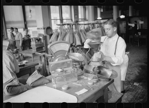 Untitled photo, possibly related to: Grain inspector at state grain inspection deptartment, Minneapolis, Minnesota