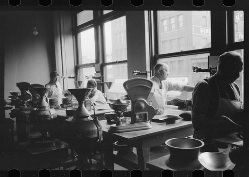 Untitled photo, possibly related to: Licensed grain inspector testing wheat for impurities, Minneapolis, Minnesota