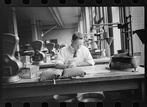 Untitled photo, possibly related to: Licensed grain inspector testing wheat for impurities, Minneapolis, Minnesota