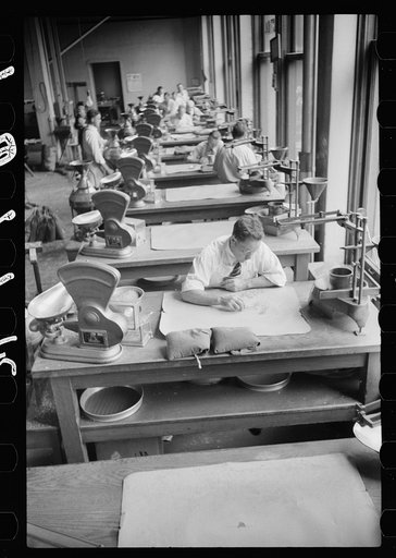 Untitled photo, possibly related to: Licensed grain inspector testing wheat for impurities, Minneapolis, Minnesota