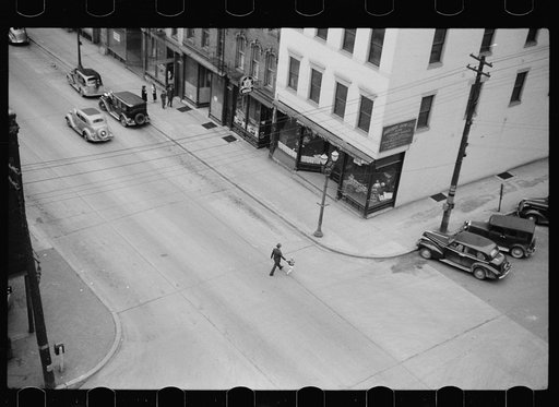 Man and boy crossing the street, Dubuque, Iowa