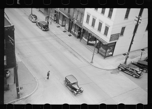 Untitled photo, possibly related to: Man and boy crossing the street, Dubuque, Iowa