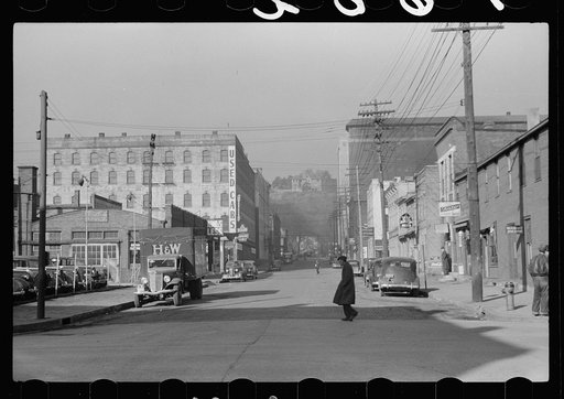 Business  section, Dubuque, Iowa. The rich live in houses on the cliffs seen in background