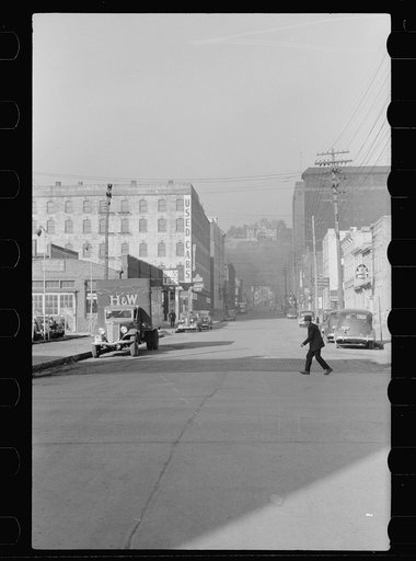 Untitled photo, possibly related to: Business  section, Dubuque, Iowa. The rich live in houses on the cliffs seen in background