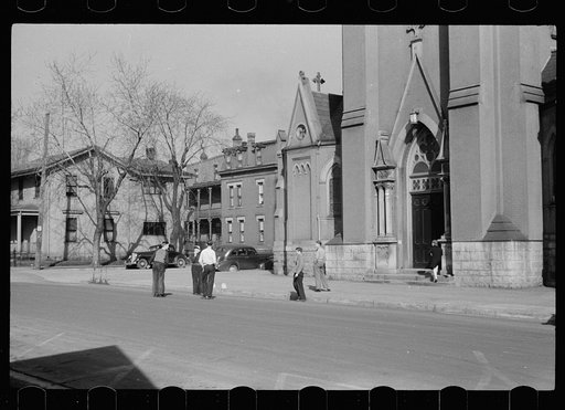 Parochial school children playing in front of church, before the school bell, Dubuque, Iowa