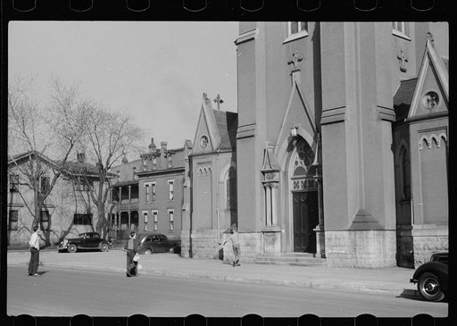 Untitled photo, possibly related to: Parochial school children playing in front of church, before the school bell, Dubuque, Iowa