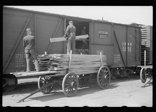 Untitled photo, possibly related to: Unloading lumber at sash and door mill, Dubuque, Iowa