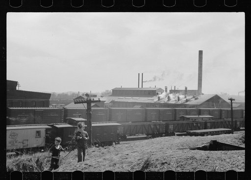 Untitled photo, possibly related to: Boys playing with bows and arrows near railroad yards, Dubuque, Iowa