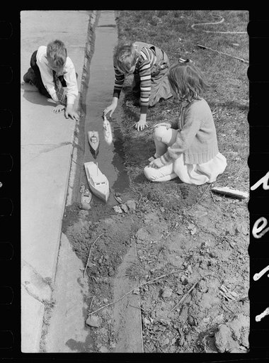 Children playing with boats, Grundy Center, Iowa