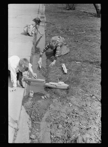 Untitled photo, possibly related to: Children playing with boats, Grundy Center, Iowa