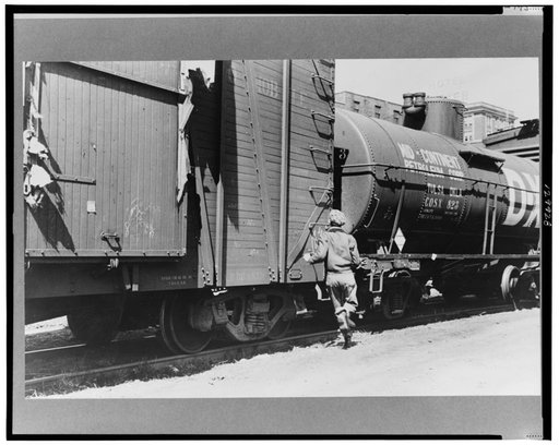 Boy hopping freight train, Dubuque, Iowa